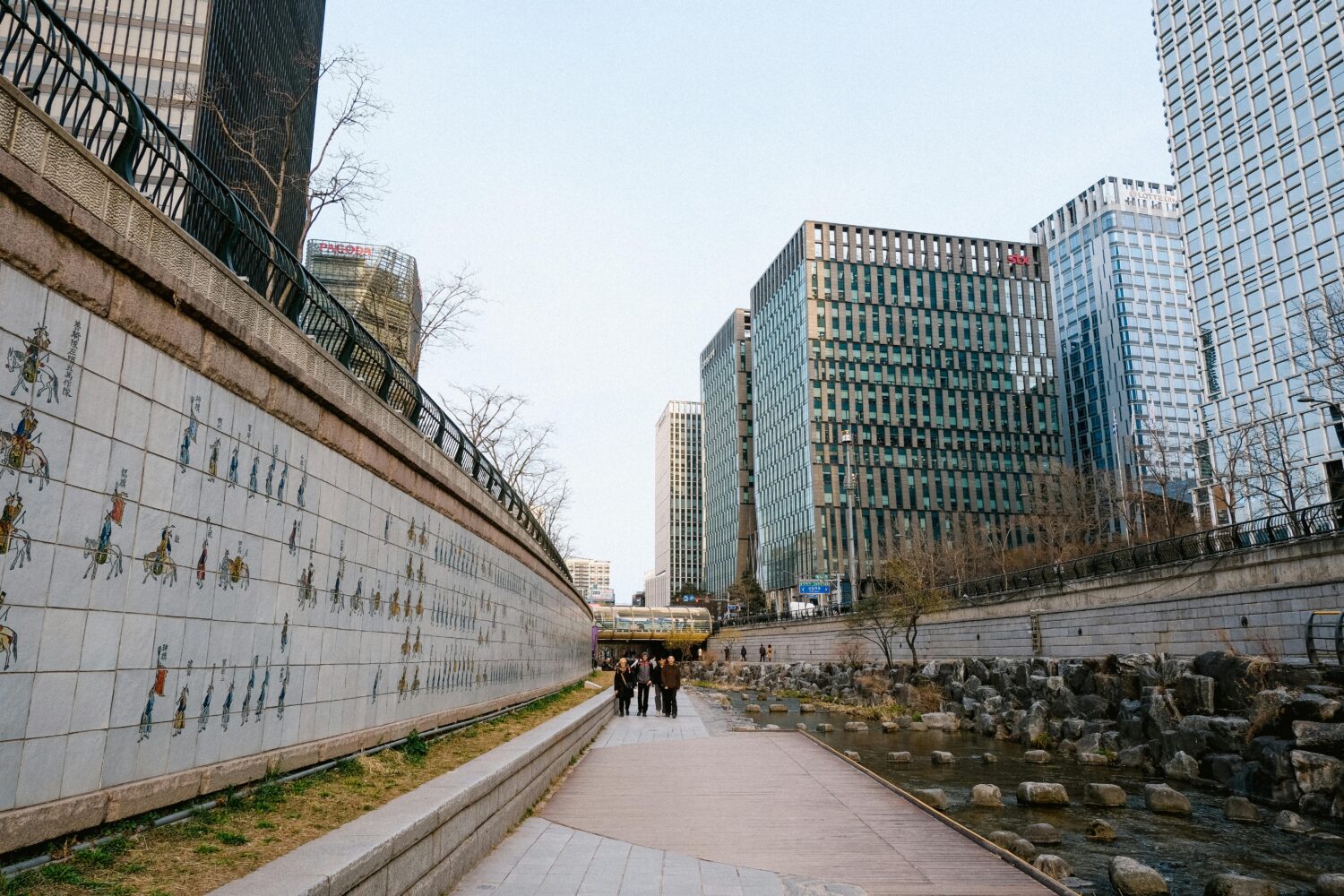 Riverwalk alongside modern Seoul skyscrapers, showcasing urban architecture and culture.